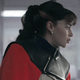 Emilia Clarke wears a ponytail and a striking black and red cape as Qi'ra in Solo: A Star Wars Story.